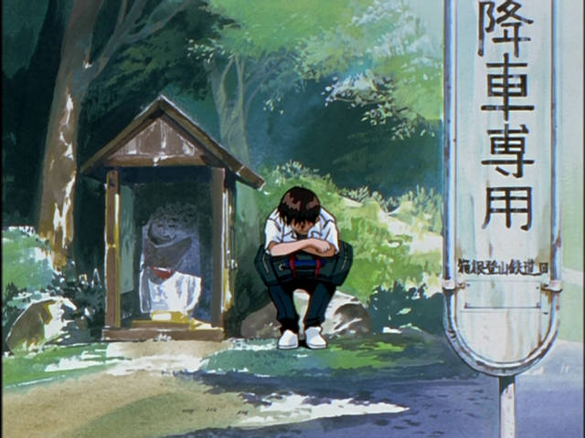 Shinji accanto alla statua di Jizo Bosatsu